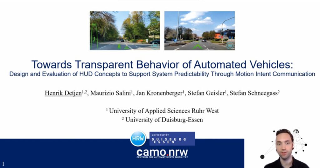 Henrik Detjen vor der Titelfolie des Vortrags zum Paper: Henrik Detjen, Maurizio Salini, Jan Kronenberger, Stefan Geisler, and Stefan Schneegass. 2021. Towards Transparent Behavior of Automated Vehicles: Design and Evaluation of HUD Concepts to Support System Predictability Through Motion Intent Communication.